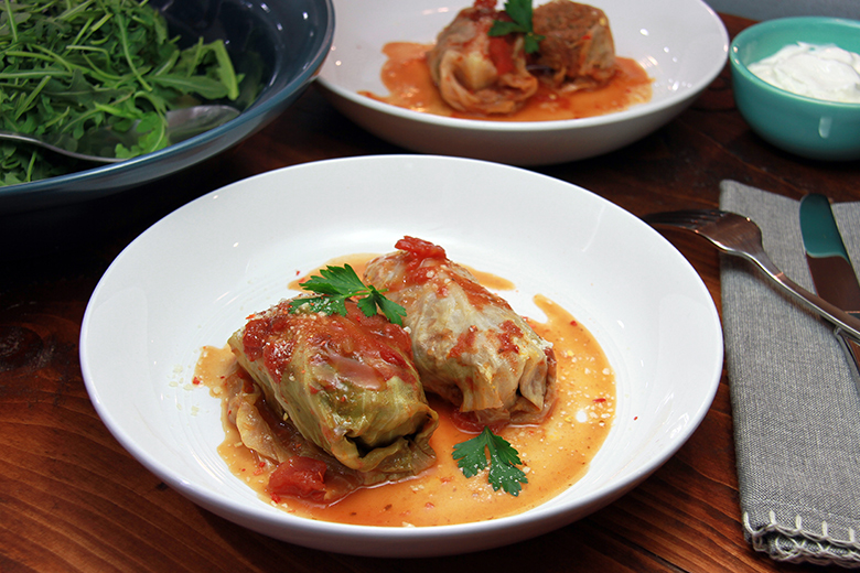 Elk Recipes & Wild Game Cooking Ideas - Elk-stuffed cabbage rolls topped with tomato sauce in a baking dish