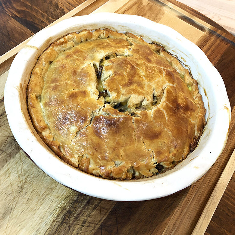 homemade venison meat pie with golden crust and venison filling