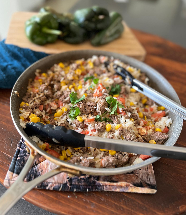 Elk stuffed poblano peppers with cornbread topping served with salsa and avocado